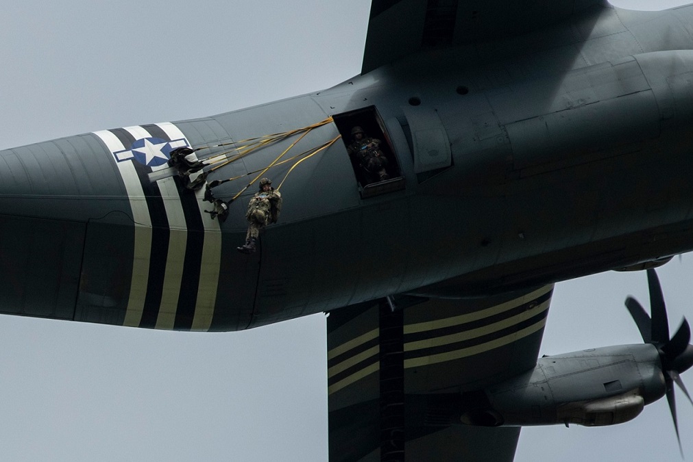 U.S. paratroopers utilizing T-11 parachutes conduct an airborne operation  from a C-130 Hercules aircraft