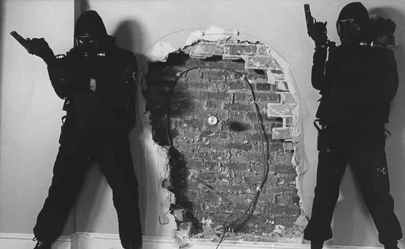 Photo of two SAS troopers preparing to breach a wall from Who Dares Wins. 